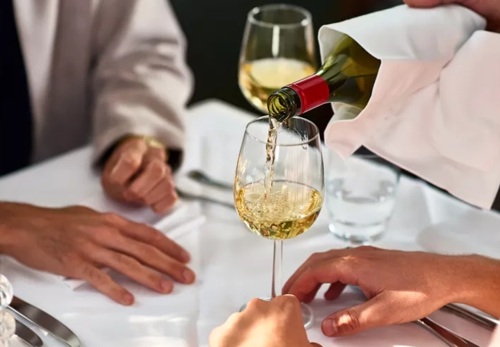 First date advice for guys. (Wine being poured into a wine glass)
